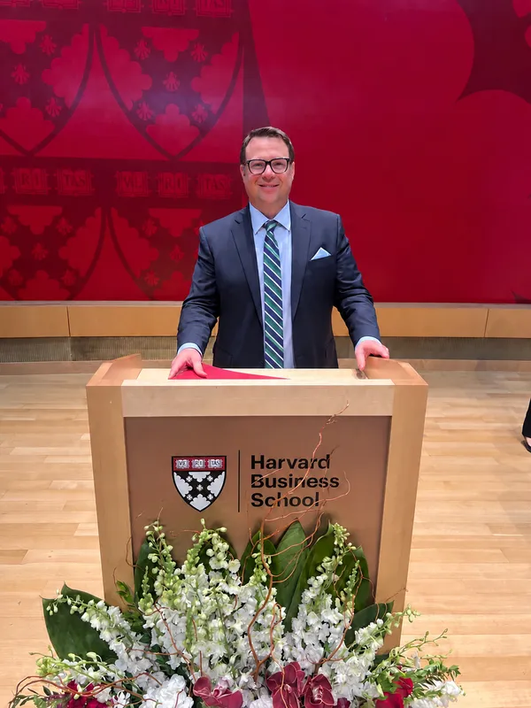 Zachary Leifer standing at a Harvard Business School lectern
